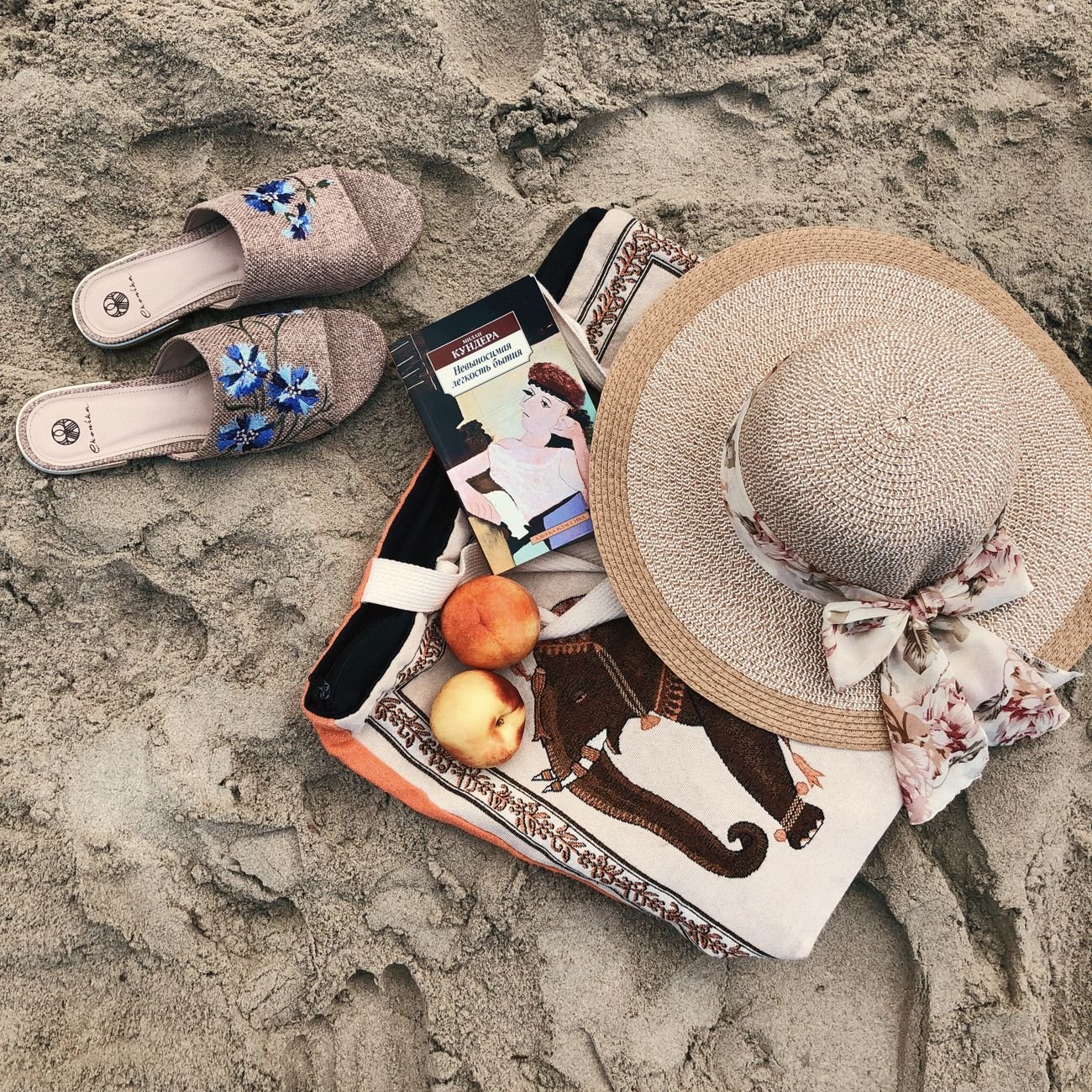 Flat lay of folded fabric and beach accessories